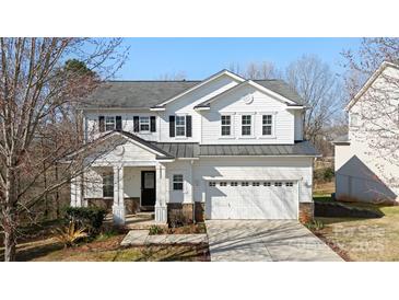 Charming two-story home with a well-manicured lawn and a two-car garage at 576 Putting Dr, Fort Mill, SC 29715
