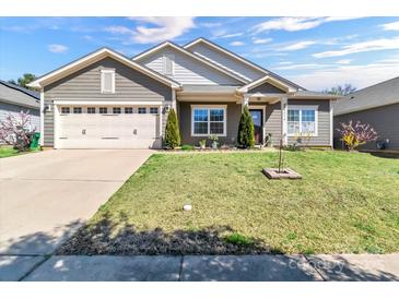Charming single-Gathering home with a well-manicured lawn and a two-car garage at 7316 Strawberry Fields Ln, Charlotte, NC 28278