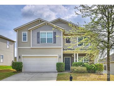Inviting two-story home featuring a two-car garage and manicured landscaping at 1309 Afternoon Sun Rd, Matthews, NC 28104