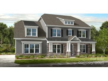Charming two-story home showcasing a stylish facade, a covered entryway, and manicured landscaping at 14703 Keyes Meadow Way, Huntersville, NC 28078