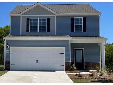 Charming two-story home featuring blue siding, black shutters, and a spacious two-car garage at 1588 Doran Ter, Richburg, SC 29729