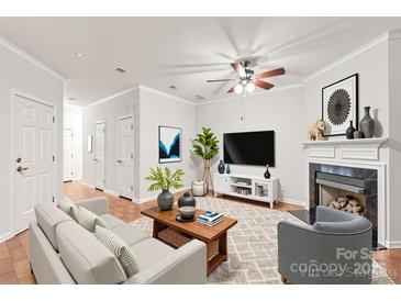 Bright living room boasts a cozy fireplace, modern furnishings, and stylish decor, creating a welcoming ambiance at 16911 Commons Creek Dr, Charlotte, NC 28277