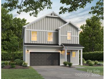 Charming two-story home with gray siding, black accents, and a well-manicured front yard at 2008 Sadler Woods Ln, Charlotte, NC 28214
