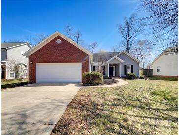 Charming single-story home with brick accents, attached garage and well-manicured front yard at 3316 Creek Trail Rd, Indian Trail, NC 28079