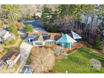 Stunning lakefront home with modern design, solar panels, a gazebo, and a lush green lawn at 340 Topsail Rd, Salisbury, NC 28146