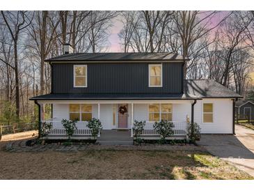 Charming two-story home with a covered front porch and white and gray siding at 412 Montana Dr, Gastonia, NC 28056