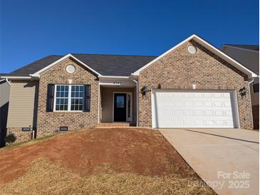 Charming single-Gathering home featuring a brick facade, attached garage, and well-lit entryway at 4166 Saltwood Dr, Hickory, NC 28602