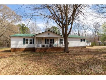 Charming single-story home features a welcoming porch and a large yard with mature trees at 5212 Old Concord Rd, Salisbury, NC 28146