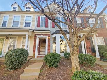 Charming townhome with brick accents, red shutters, and a well-maintained front yard at 8813 Gerren Ct, Charlotte, NC 28217