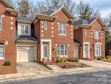 Charming red brick townhome with a well-maintained front yard and inviting entrance at 1141 Hollyheath Ln, Charlotte, NC 28209