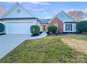 Charming home with a two-car garage, brick accents and well-manicured landscaping at 12308 Ridge Cove Cir, Charlotte, NC 28273