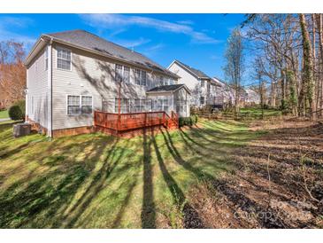 Expansive backyard featuring a wooden deck, lush lawn and mature trees, perfect for outdoor entertaining at 14333 Maclauren Ln, Huntersville, NC 28078