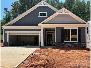 New construction home featuring a two-car garage, stone accents, and stylish gray siding at 149 Prestwick Way # 39, Mooresville, NC 28115