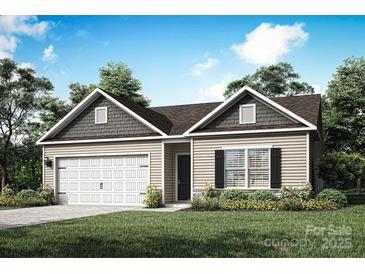 Charming single-story home featuring a two-car garage, complemented by a beautifully landscaped front yard at 3336 Burberry Dr, Gastonia, NC 28052