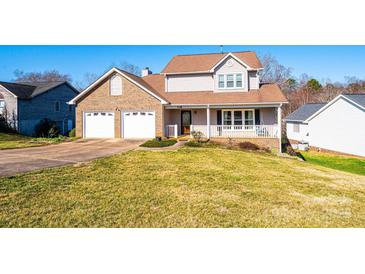 Charming two-story home featuring a brick facade, covered porch, two-car garage, and well-manicured lawn at 538 30Th Avenue Ne Cir, Hickory, NC 28601