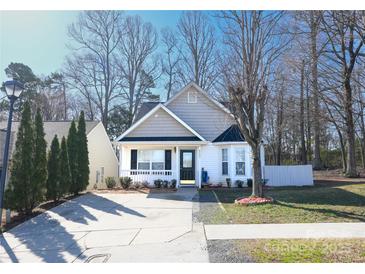 Charming single-story home with a well-manicured front yard and inviting front porch at 8421 Kings Creek Dr, Charlotte, NC 28273