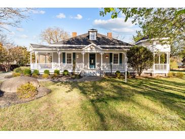 Charming home featuring a wide porch, well-maintained landscaping, and a classic architectural style at 1135 Old Charlotte Rd, Concord, NC 28027