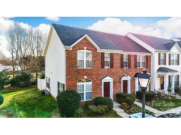 Charming brick townhome featuring a well-manicured lawn and inviting entryway, ideal for comfortable living at 1965 Charlotte Hwy # 401, Mooresville, NC 28115