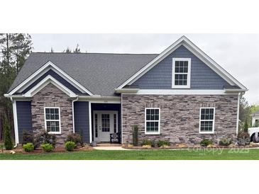 Charming single-story home with stone and siding accents, complemented by a well-manicured lawn at 506 Muirfield Way, Salisbury, NC 28144