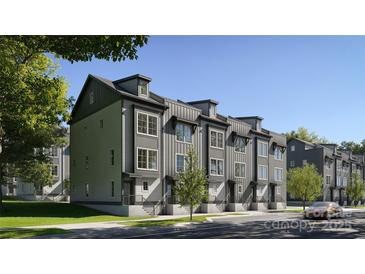 Modern townhomes with gray siding and black trim showcase a sleek, contemporary design and inviting curb appeal at 1011 Carter Ave # 35, Charlotte, NC 28206