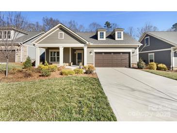 Charming one-story home featuring a manicured lawn and a two-car garage, perfect for comfortable living at 1063 Millview Ln, Matthews, NC 28104