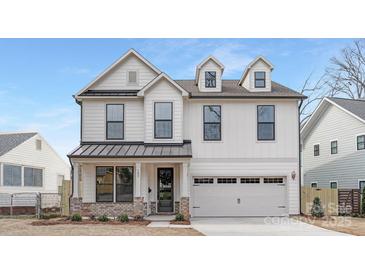 Stunning two-story home showcasing a modern design with white siding, black accents, and a welcoming front porch at 109 Seldon Dr, Charlotte, NC 28216