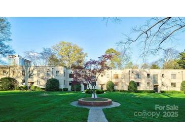 Apartment complex with well-manicured lawn and colorful trees in a park-like setting at 1121 Myrtle Ave # 17, Charlotte, NC 28203