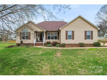 Charming one-story home featuring manicured lawn, neutral siding, and a welcoming front porch at 1278 Gracebrook Dr, Salisbury, NC 28147