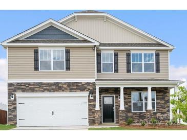Charming two-story home featuring a stone facade, two-car garage, and well-maintained landscaping at 1420 6Th Ne St, Hickory, NC 28601