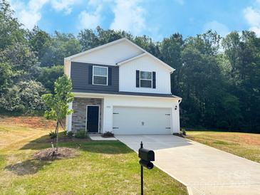 Charming two-story home featuring a mix of siding and stone accents, plus a two-car garage at 200 Lake George Dr, Shelby, NC 28152