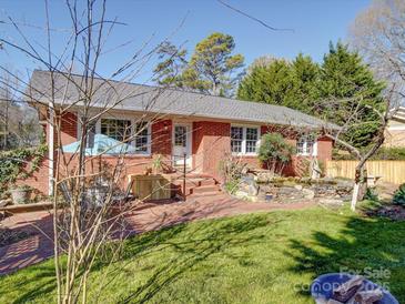 Charming brick home with landscaped yard and a small waterfall feature at 2036 Edgewater Dr, Charlotte, NC 28210