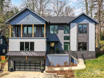 Stunning modern home with a balcony, brick accents, and a convenient two-car garage at 3416 Windsor Dr, Charlotte, NC 28209