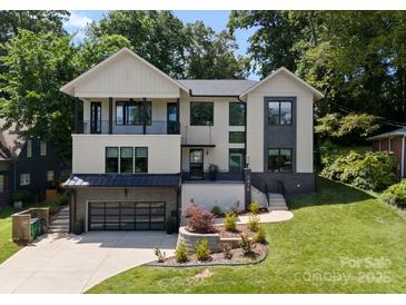 Attractive modern home with manicured lawn and a black garage door, creating a welcoming curb appeal at 3416 Windsor Dr, Charlotte, NC 28209