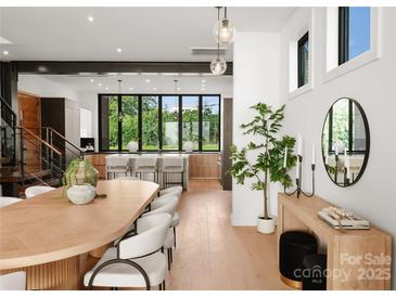 Open concept dining area features contemporary decor, stylish seating, and natural lighting at 5500 Carmel Rd # 103, Charlotte, NC 28226