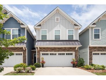 Charming two-story home with gray siding, stone accents, and a two-car garage at 7456 Hartsfield Dr, Lancaster, SC 29720