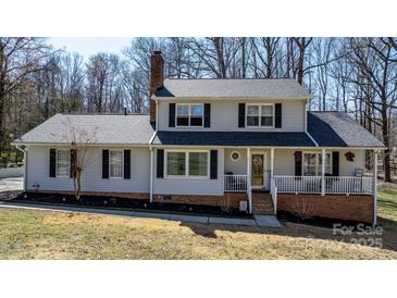 Charming two-story home with black shutters and a welcoming front porch at 8125 Appaloosa Ln, Charlotte, NC 28215