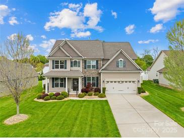 Beautiful two-story home with manicured lawn, stone accents, and an attached two-car garage at 963 Brookdale Ln, Stanley, NC 28164