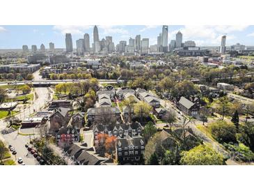 An aerial view showing the neighborhood and the city skyline in the background at 1525 Walnut View Dr, Charlotte, NC 28208