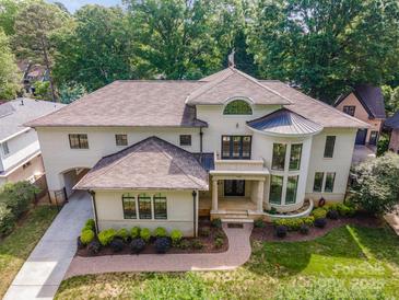 Aerial view of a stunning cream-colored home with a beautiful roof and lush landscaping, offering great curb appeal at 1665 Sterling Rd, Charlotte, NC 28209