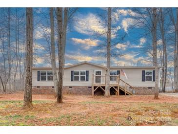 Charming ranch-style home with a welcoming front porch and beautiful, expansive wooded front yard at 1795 Kestrel Valley Ln, Catawba, NC 28609