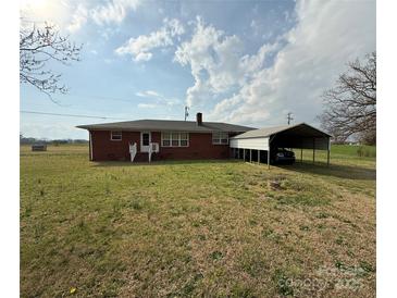 Charming red brick home featuring a carport and spacious yard at 2730 Medlin Rd, Monroe, NC 28112