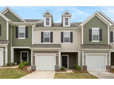 Charming townhome with attached garage, dormer windows, and modern color palette at 2749 Yeager Nw Dr, Concord, NC 28027
