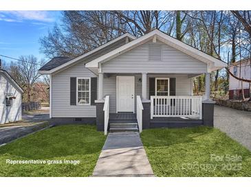 Charming single-story home featuring a cozy front porch and freshly painted exterior at 310 Pineview St, Kannapolis, NC 28083