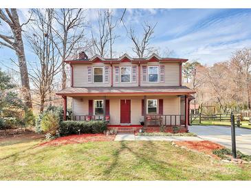 Charming two-story home with a covered front porch and well-manicured landscaping at 335 Deep Forest Ct, Gastonia, NC 28056