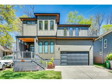 Contemporary two-story home with a gray exterior, fenced front porch, and a matching attached garage at 805 E 19Th St, Charlotte, NC 28205