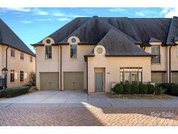 Elegant two-story home with a dual-car garage and appealing architectural details and well-maintained landscaping at 8812 Provence Village Ln, Charlotte, NC 28226