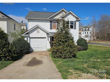 Charming two-story home with landscaped yard and driveway at 1421 Braveheart Ln, Charlotte, NC 28216