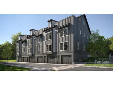 Modern townhome featuring an attached garage, board and batten siding, and large windows for natural light at 3003 Casting St # 12, Charlotte, NC 28206