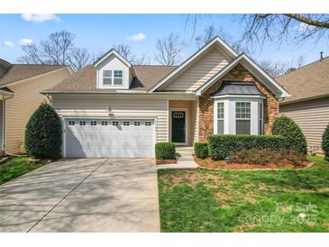 Charming home with a two-car garage, stone accents, and well-maintained landscaping at 3104 Streamhaven Dr, Indian Land, SC 29707