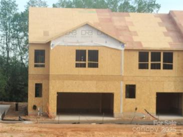Two-story DRB home under construction with an attached two-car garage at 4127 Walking Ridge Rd # 53, Charlotte, NC 28208